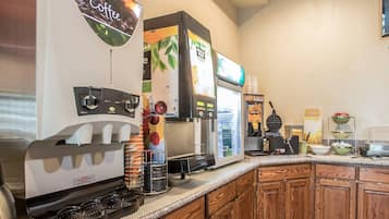 A coffee station with a coffee machine, a water dispenser, and a beverage dispenser.