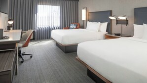 A hotel room with two beds, a desk, a chair, and a large window with curtains. - Courtyard by Marriott Farmington (Farmington)