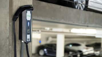 An electric vehicle charging station in a parking garage.
