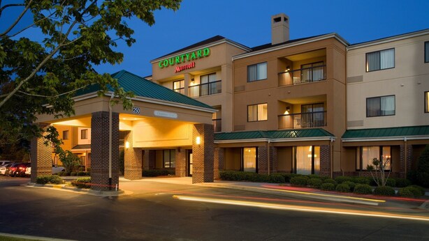 A Courtyard Marriott hotel with a brick facade, multiple balconies, and a green roof. - Courtyard by Marriott Rocky Mount (Rocky Mount)