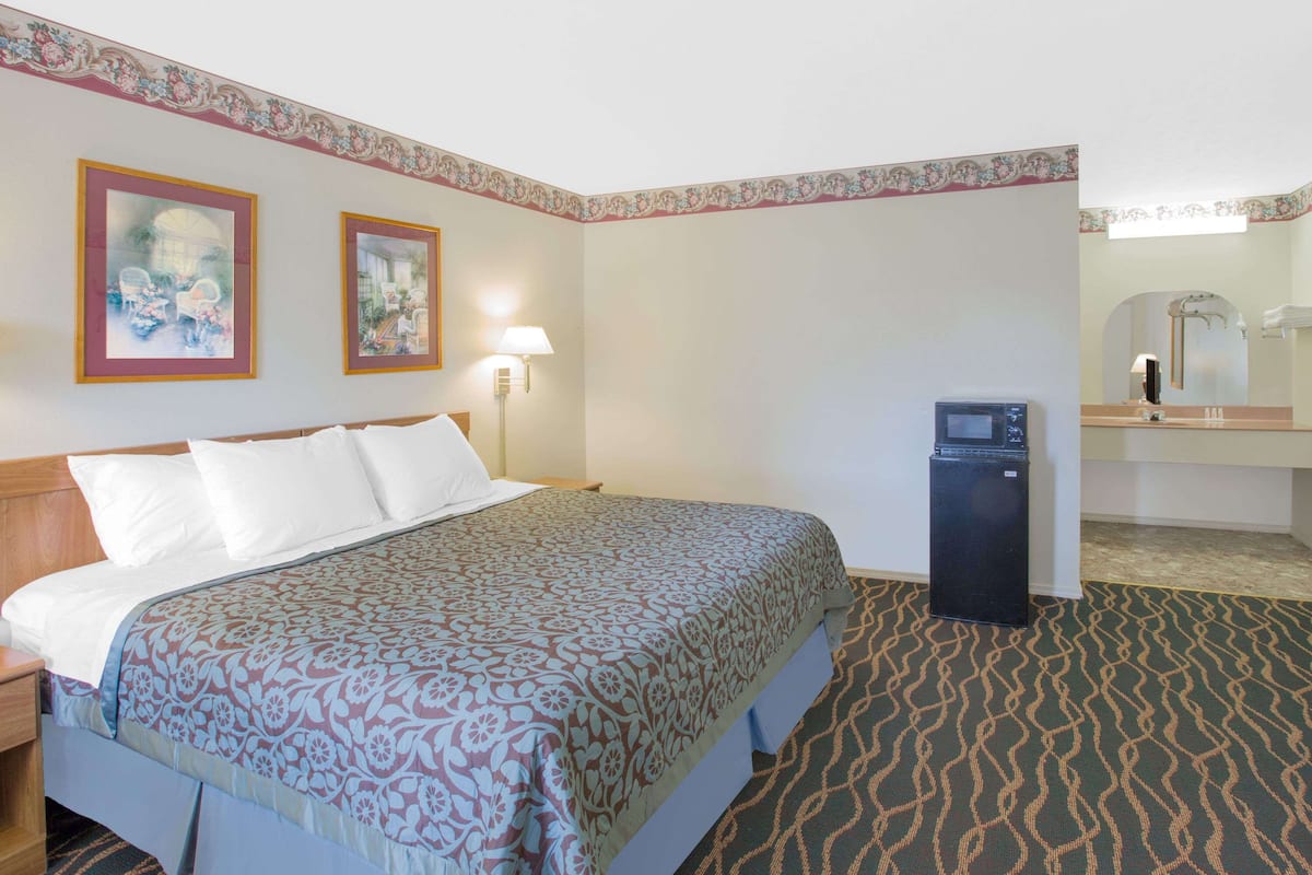 Suite, 1 King Bed, Non Smoking, Jetted Tub | Desk, laptop workspace, blackout curtains, iron/ironing board