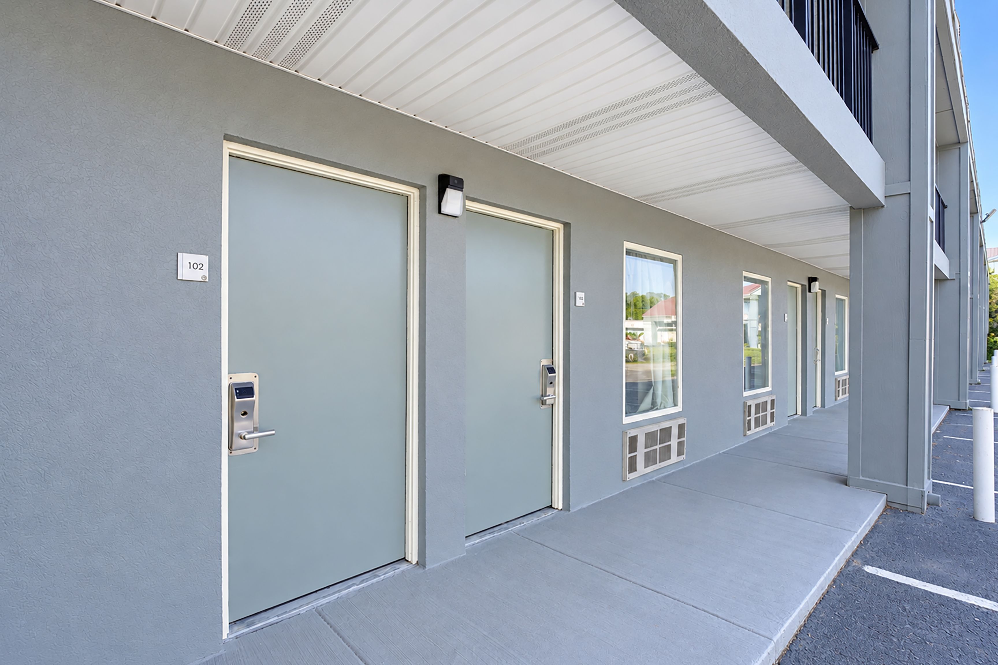 A row of doors with numbered signs, indicating a hotel or similar accommodation.