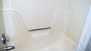 A bathroom with a bathtub, a shower, and a toilet. - Liberty Inn (Waynesboro)