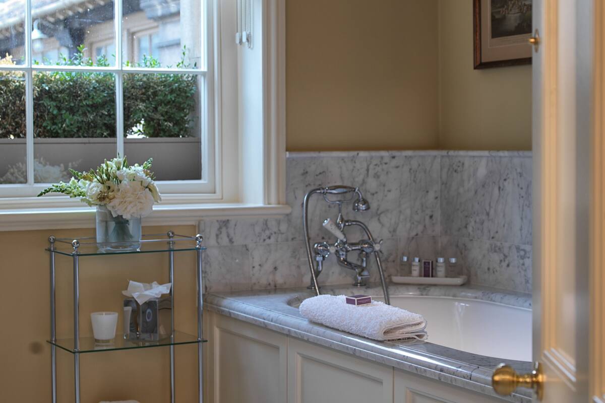 designer toiletries, hair dryer, bathrobes, slippers