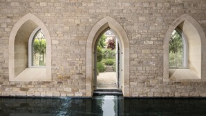 A stone building with three arched windows and a pool in front. - The Royal Crescent Hotel & Spa (Bath)