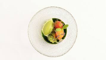 A top-down view of a dish on a textured white plate.