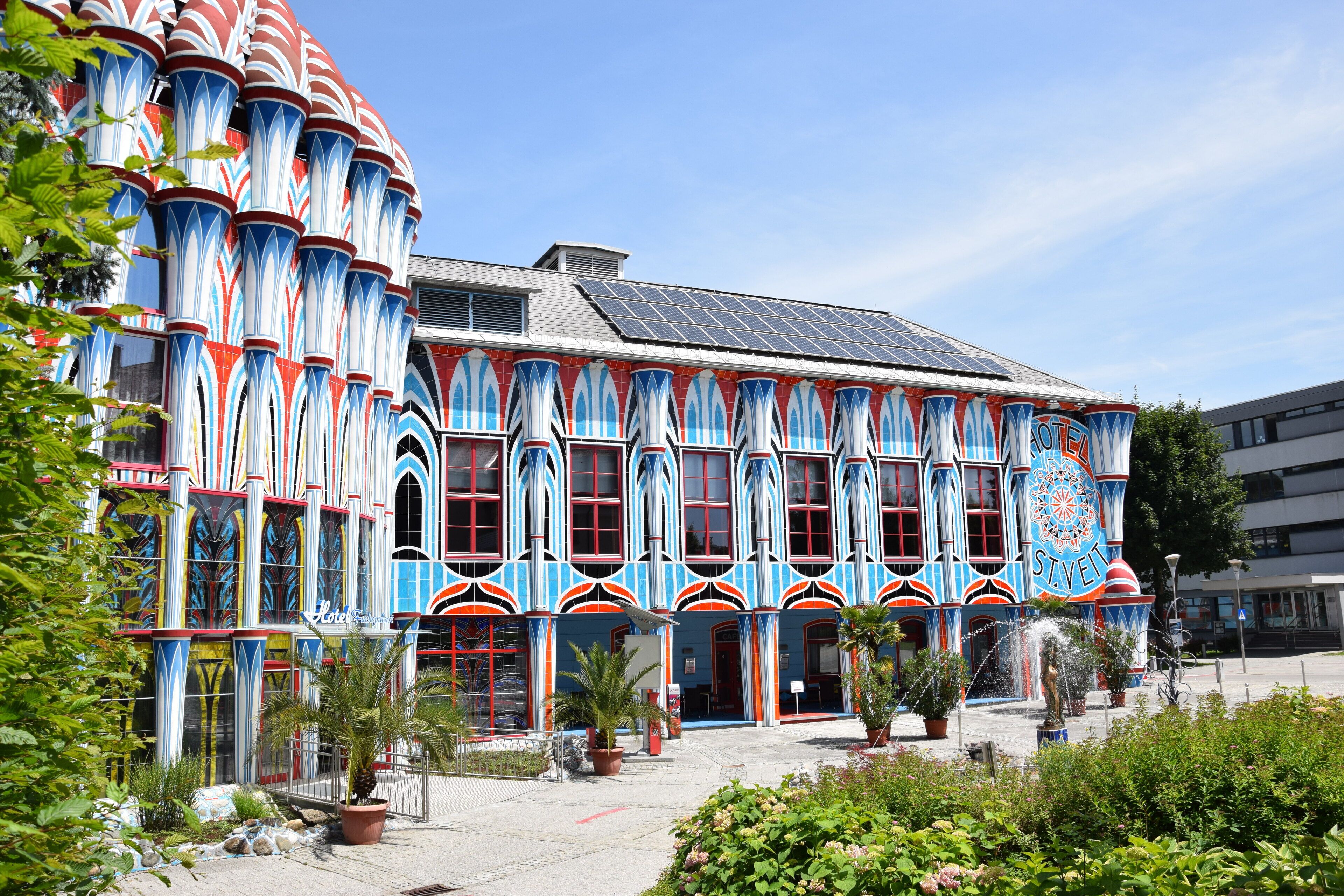 A building with a distinctive architectural style featuring tall, narrow windows and a colorful facade.