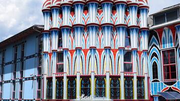 A colorful building with a distinctive architectural design, featuring a series of arches and a central dome.