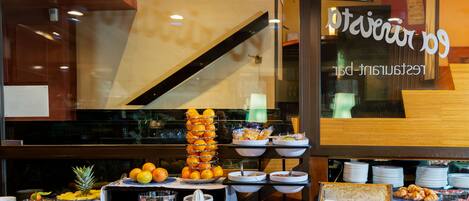 A buffet setup with various food items and a piano in the background.