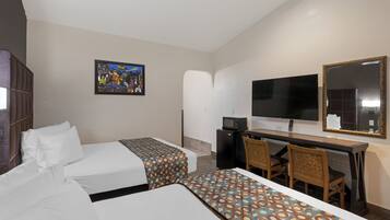 A hotel room with two beds, a desk with a chair, a TV, and a mirror.
