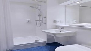 A modern bathroom with a shower, sink, and toilet. - Travelodge Ludlow Woofferton (Ludlow)