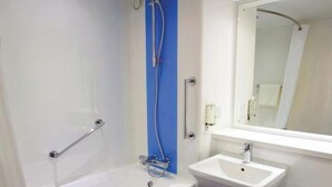 A bathroom with a bathtub, a sink, and a toilet. - Travelodge Barnsley (Barnsley)