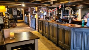 A bar area with wooden cabinets, a counter, and various bottles and glasses. -  Casa Mere Hotel, Sure Collection by Best Western, Knutsford Cheshire (Knutsford)