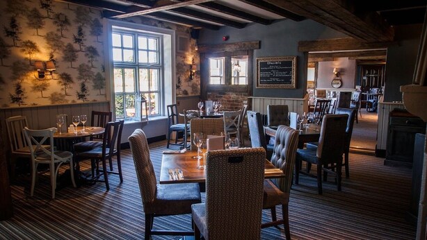 A cozy restaurant with wooden beams, patterned wallpaper, and a mix of upholstered and wooden chairs. -  Casa Mere Hotel, Sure Collection by Best Western, Knutsford Cheshire (Knutsford)