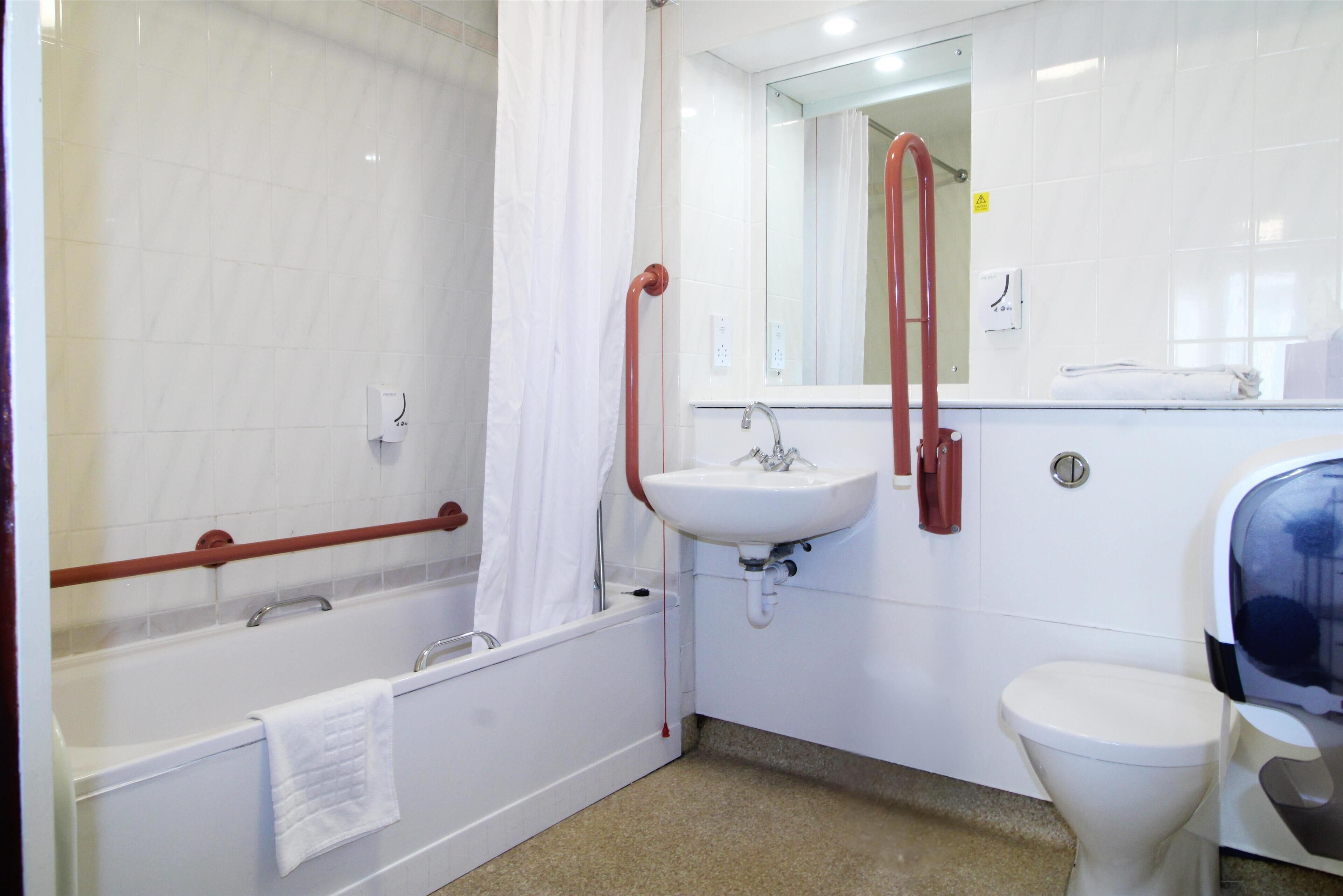 A bathroom with a bathtub, a sink, and a toilet.