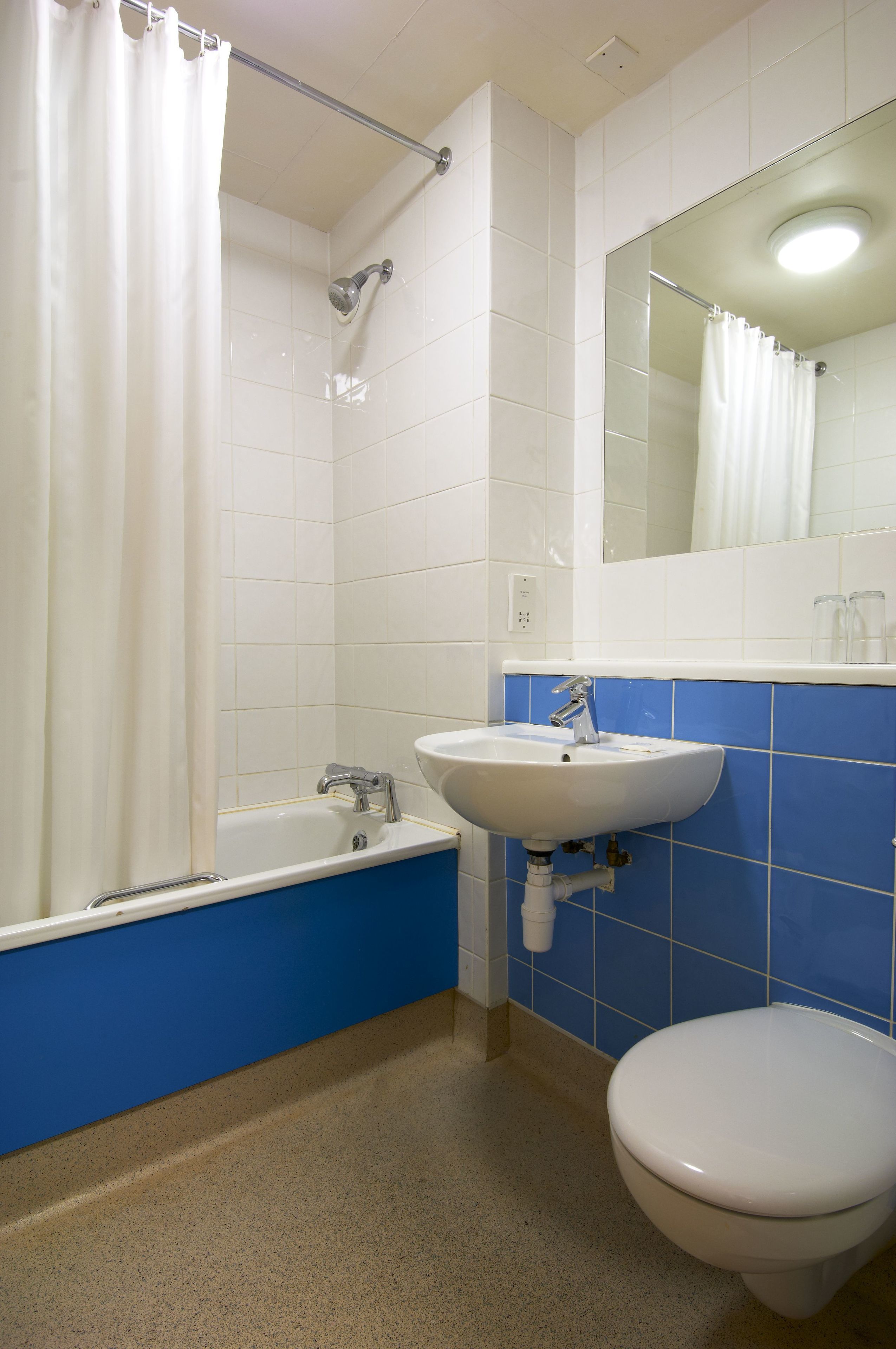 A bathroom with a bathtub, sink, and toilet.