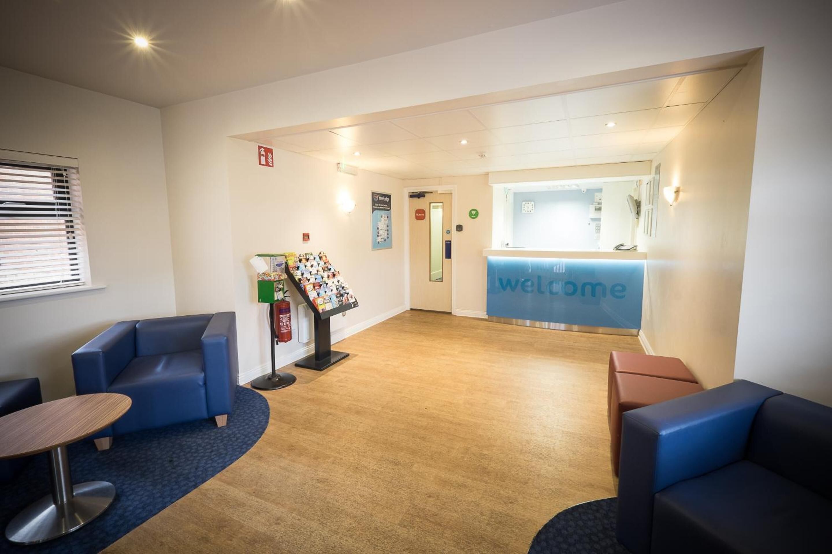 A reception area with a 'Welcome' sign, a reception desk, and seating arrangements.