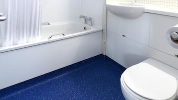 A bathroom with a bathtub, shower, toilet, and sink.