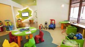 A children's play area with colorful furniture, a table with papers, and toys. - Holiday Inn Resort Vanuatu by IHG (Port Vila)