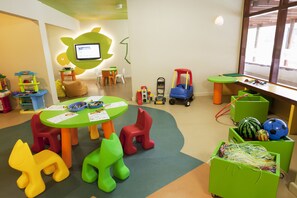 A children's play area with colorful furniture, a table with papers, and toys. - Holiday Inn Resort Vanuatu by IHG (Port Vila)