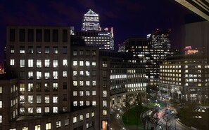 A nighttime cityscape with illuminated buildings, including a prominent bank with 'CREDIT SUISSE' signage.