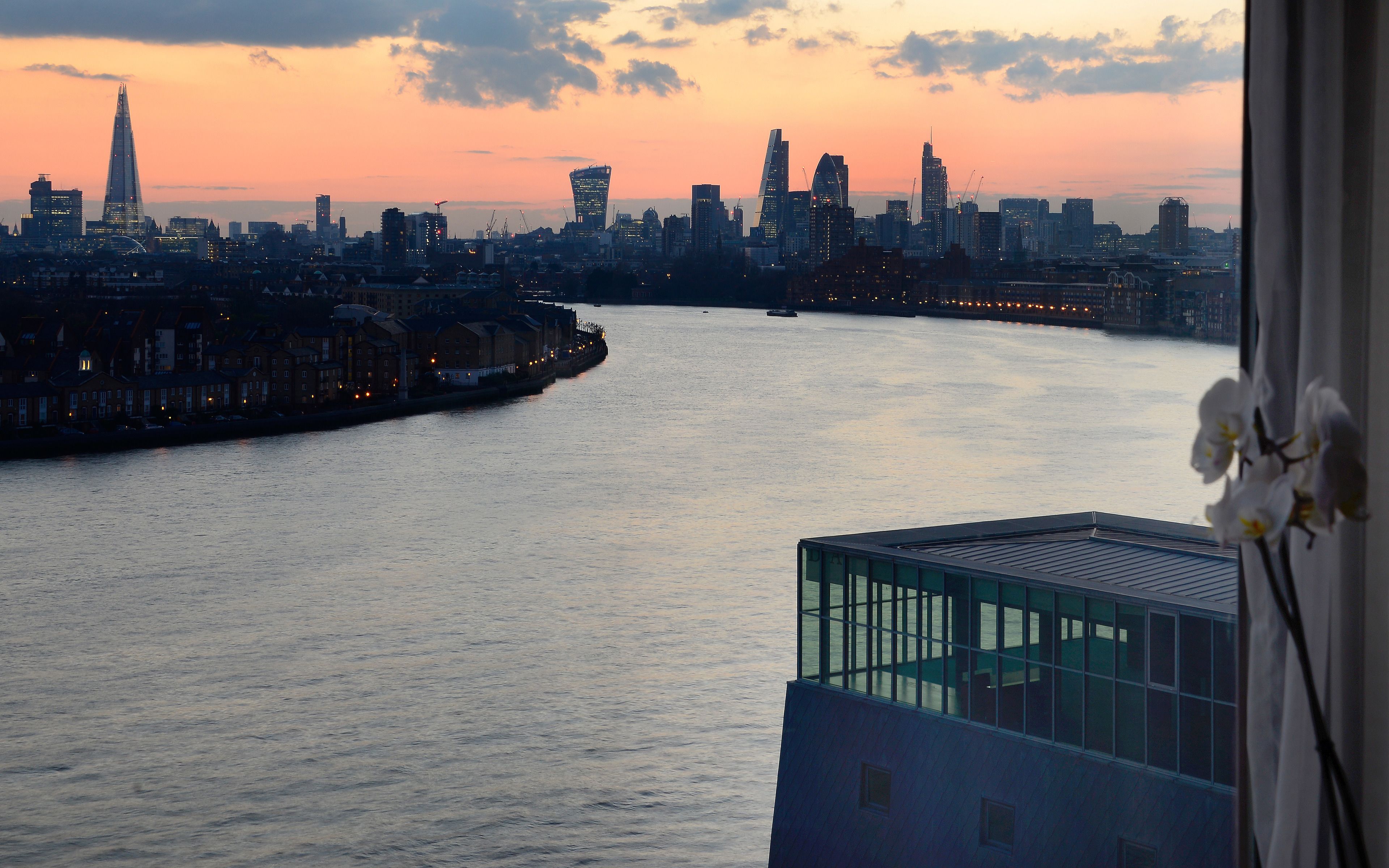 A river with a city skyline in the background.