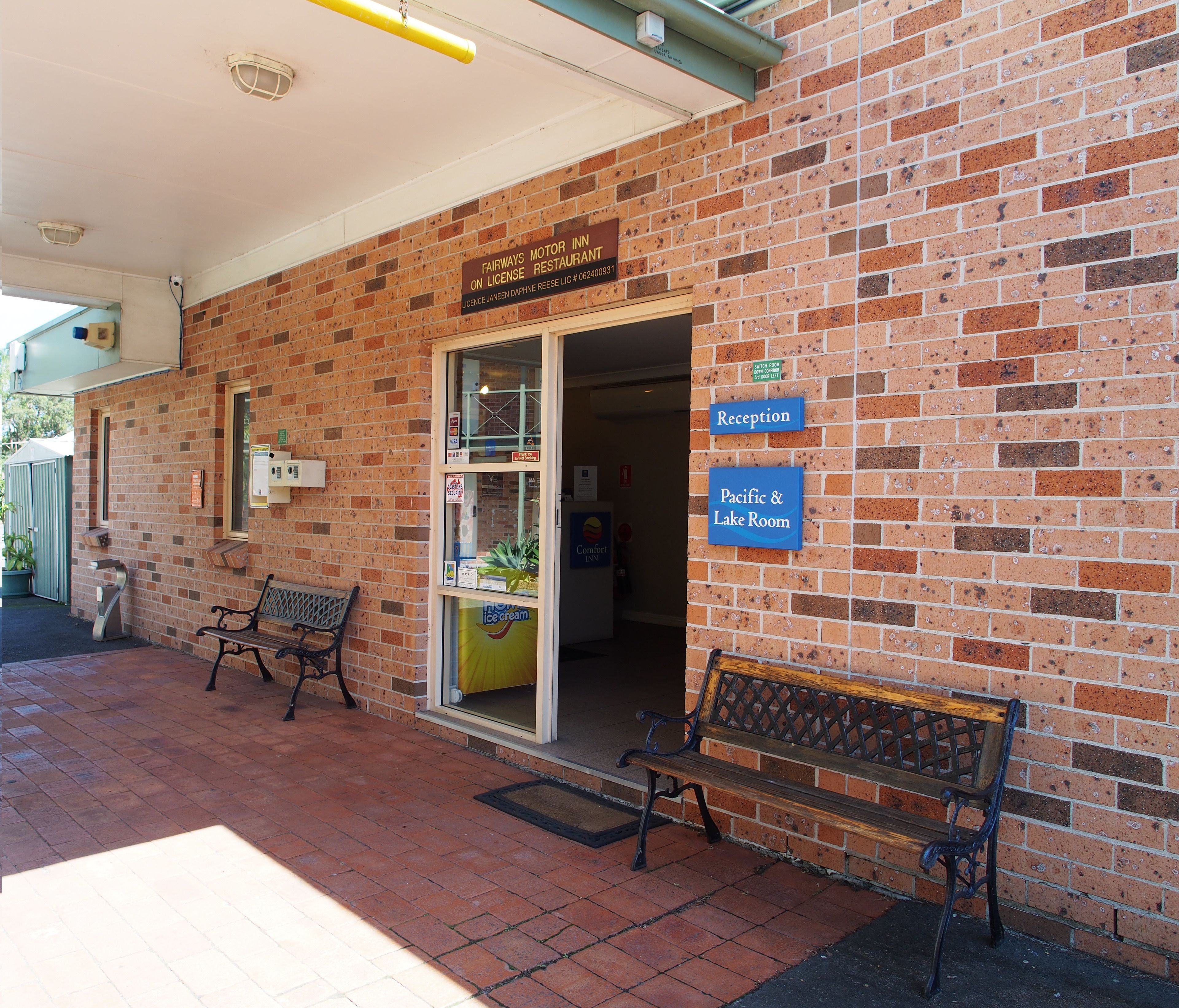 A brick building with a sign for Fairways Motor Inn on license restaurant. There are signs for Reception and Pacific & Lake Room.