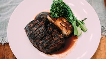 A plate with grilled meat and vegetables.