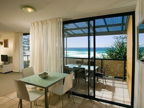 1 Bedroom Beachfront Apartment | Living area | 32-inch flat-screen TV with cable channels, TV