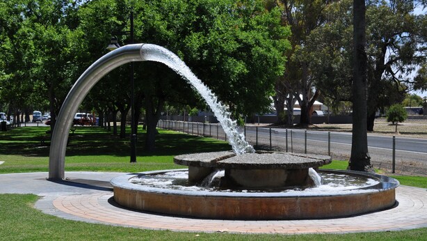 A circular fountain with water flowing from a central arch. - Keith Motor Inn (Keith)