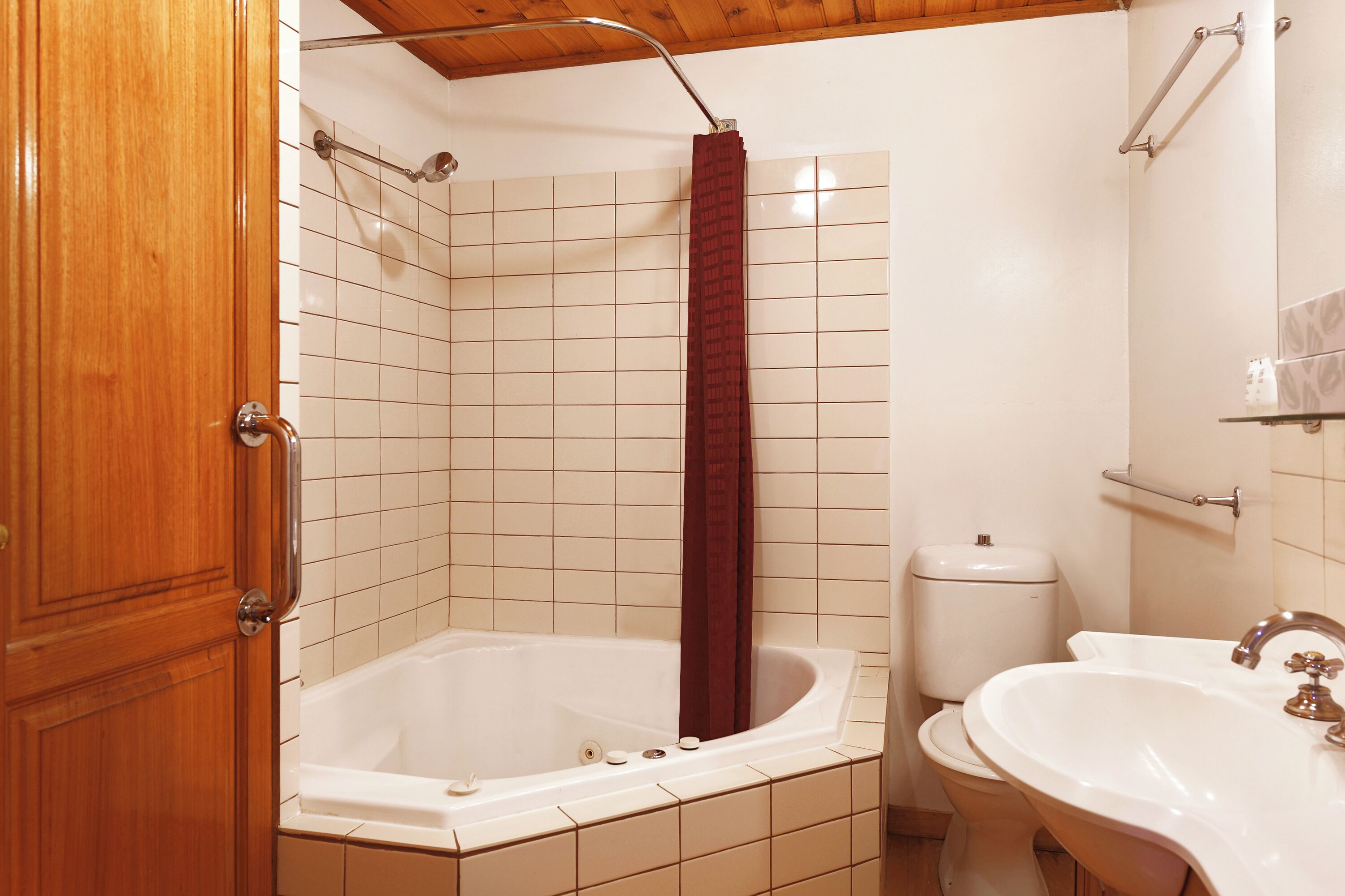 A bathroom with a bathtub, toilet, and sink.