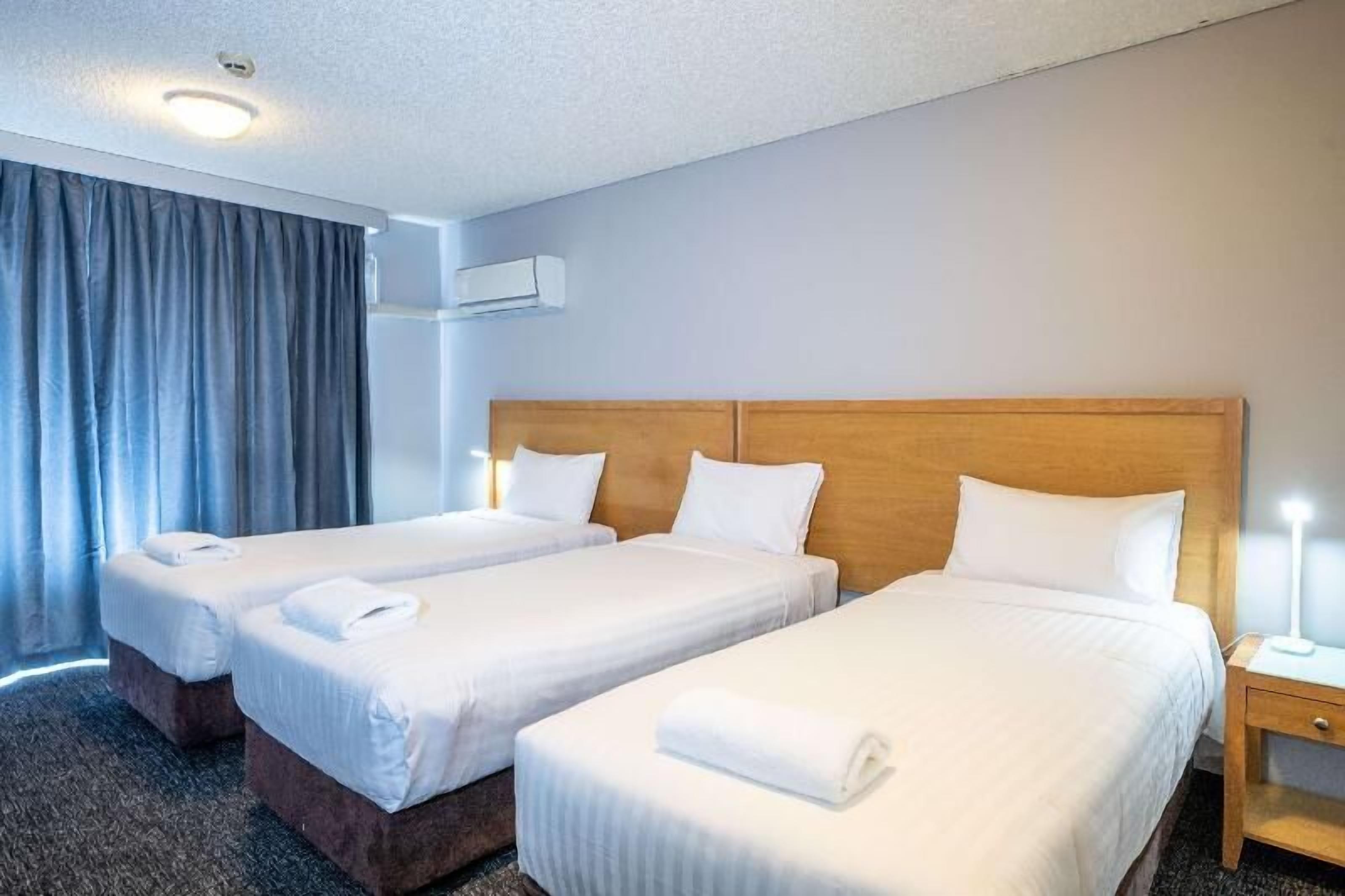 Premium bedding, laptop workspace, blackout curtains, iron/ironing board