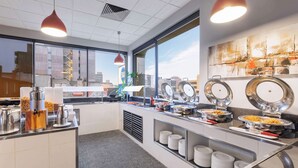 A modern breakfast bar with a city view, a coffee station, and a variety of food options. - Best Western Hobart (Hobart)