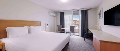 Premium bedding, laptop workspace, blackout curtains, iron/ironing board