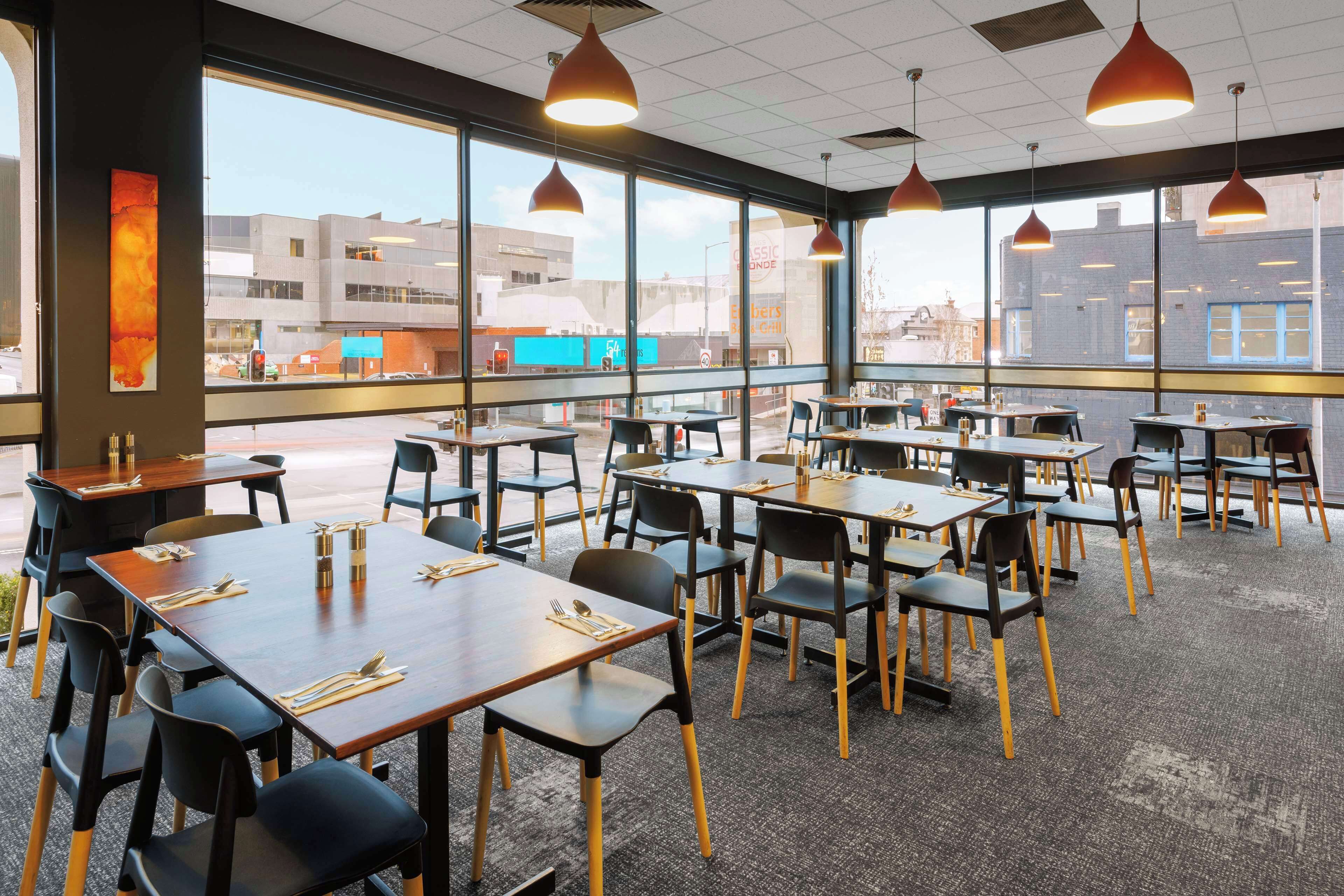 A restaurant with tables and chairs arranged for dining.