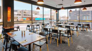 A restaurant with tables and chairs arranged for dining.