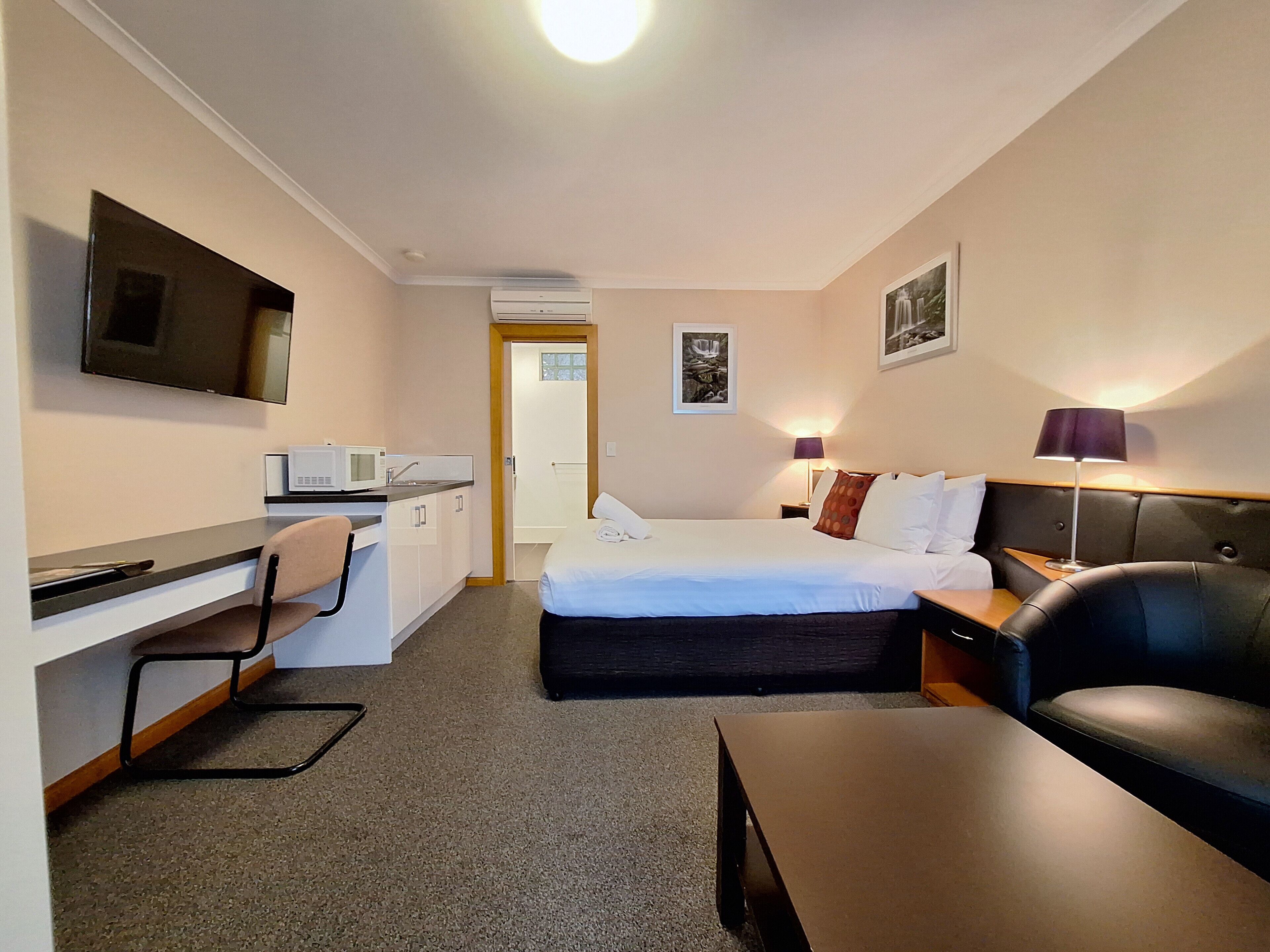 Deluxe Queen Room with Kitchenette | In-room safe, blackout drapes, iron/ironing board, free WiFi