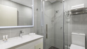 A modern bathroom with a glass-enclosed shower, a white sink, and a toilet. - Quality Hotel Melbourne Airport (Westmeadows)