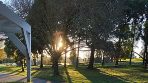 A paved pathway leading to a white gazebo, surrounded by trees and grass. - Moe Parklands Motel (Newborough)