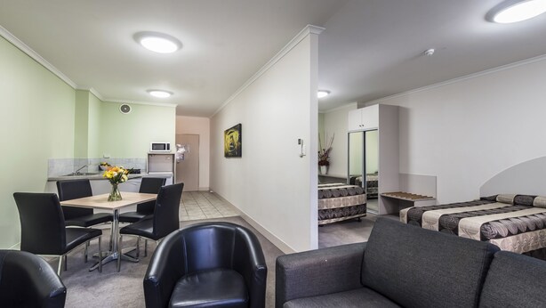 A modern room with a dining area, a kitchenette, a sofa, and a bed. - Comfort Inn & Suites Goodearth Perth (Perth)
