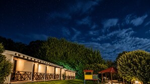 A hotel with a row of rooms, a children's play area, and a covered seating area. - Karri Forest Motel (Pemberton)