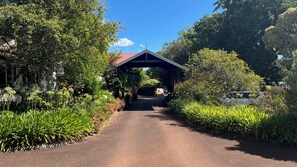 Stroll through lush gardens to a serene retreat with a distinctive red roof.