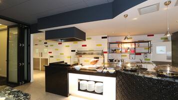 A modern kitchen with a central island, a built-in oven, and a variety of kitchen appliances.