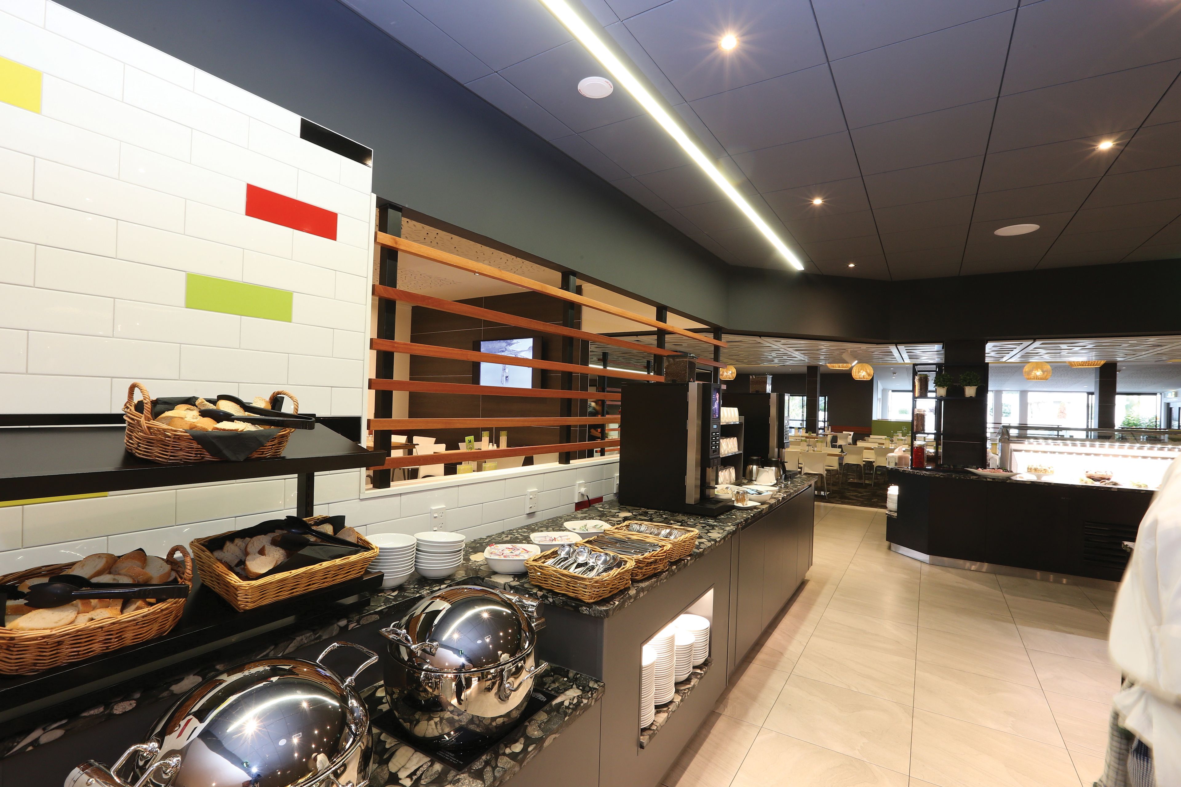A buffet area with various food items and serving utensils.