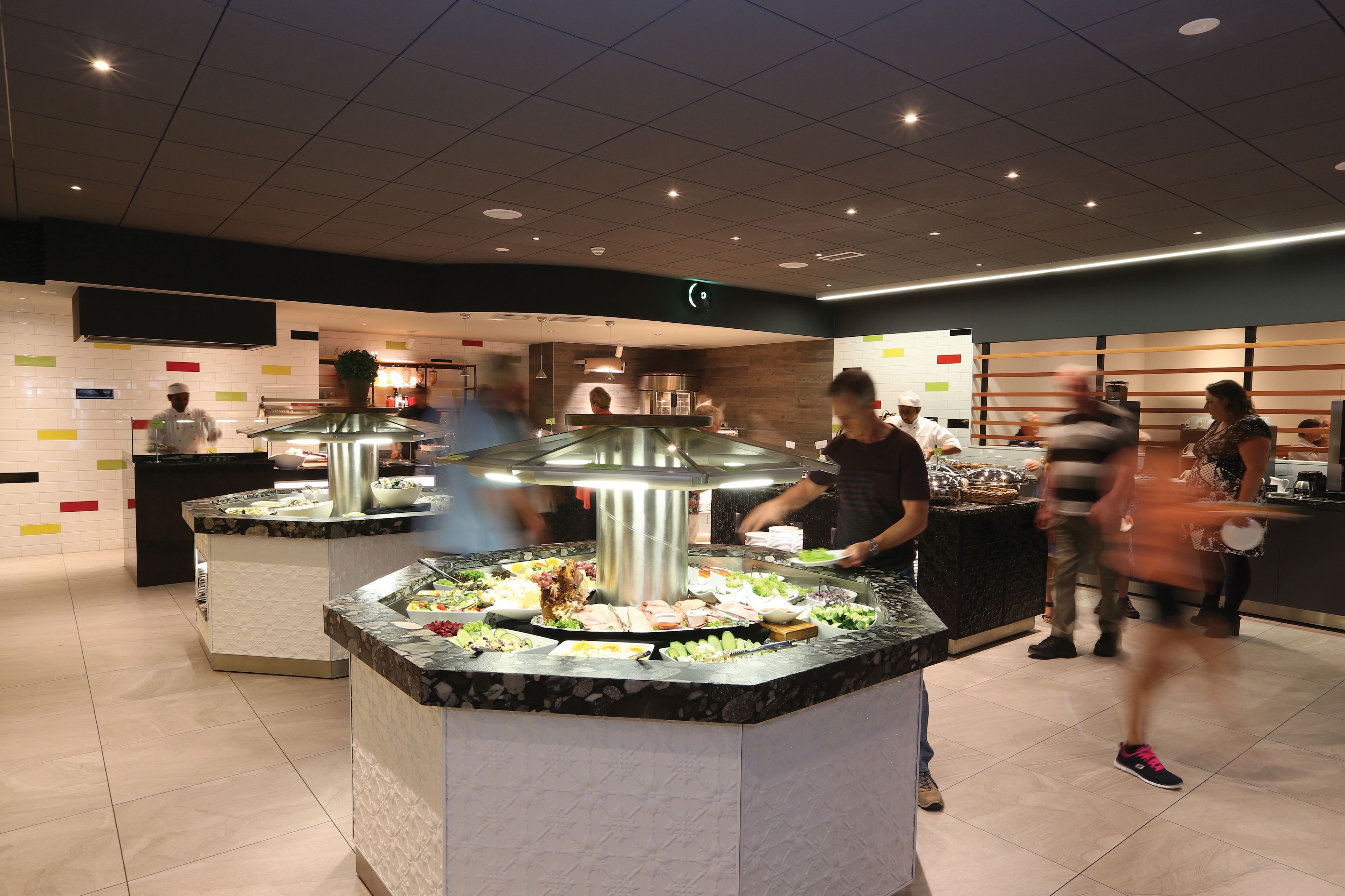 A buffet area with multiple food stations and a central grill.
