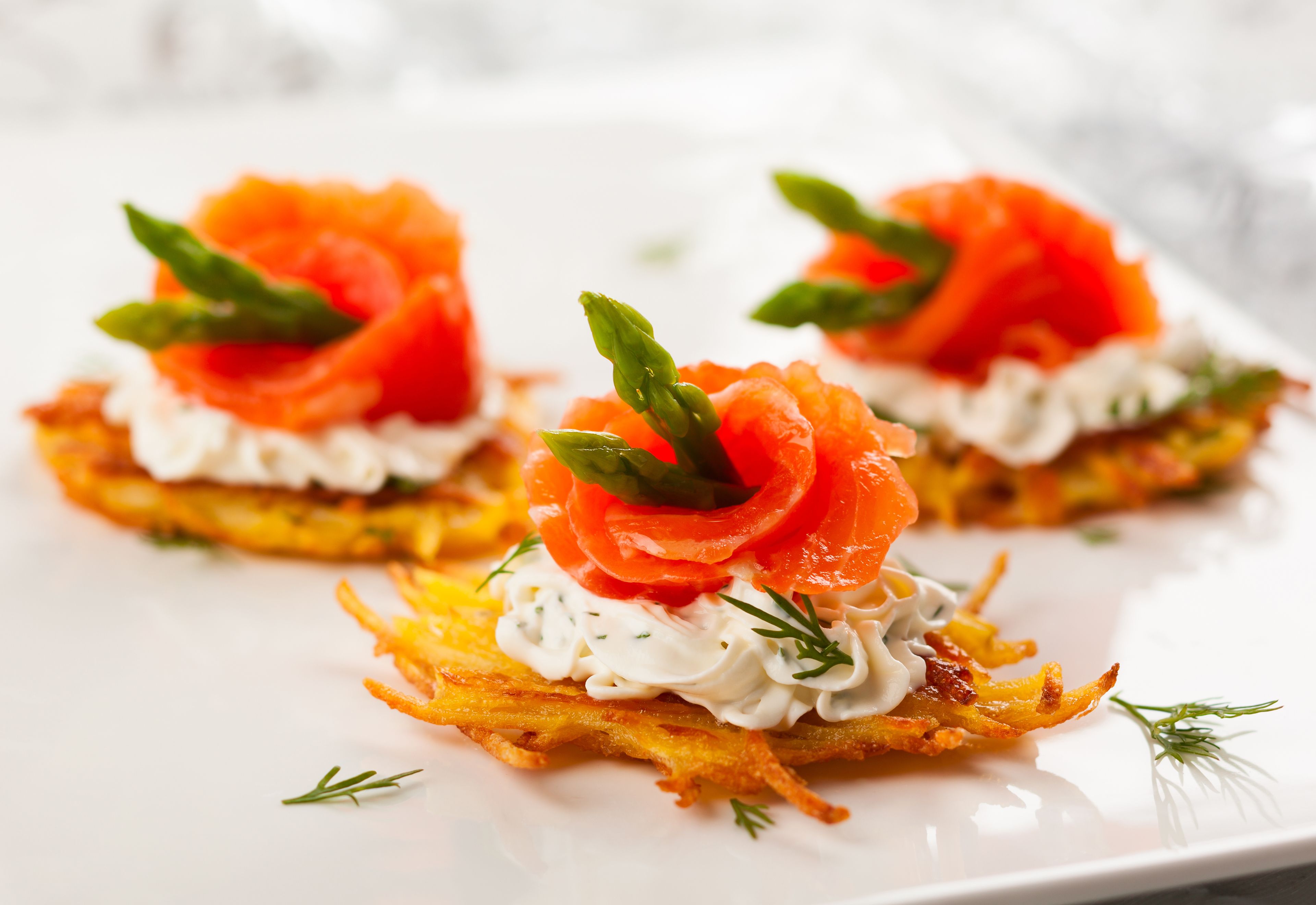 Three appetizers on a white plate.