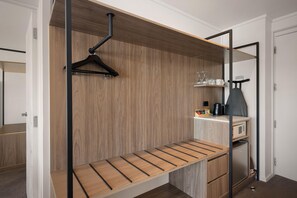 Una cocina moderna con encimera de madera, una estantería colgante y un horno empotrado.