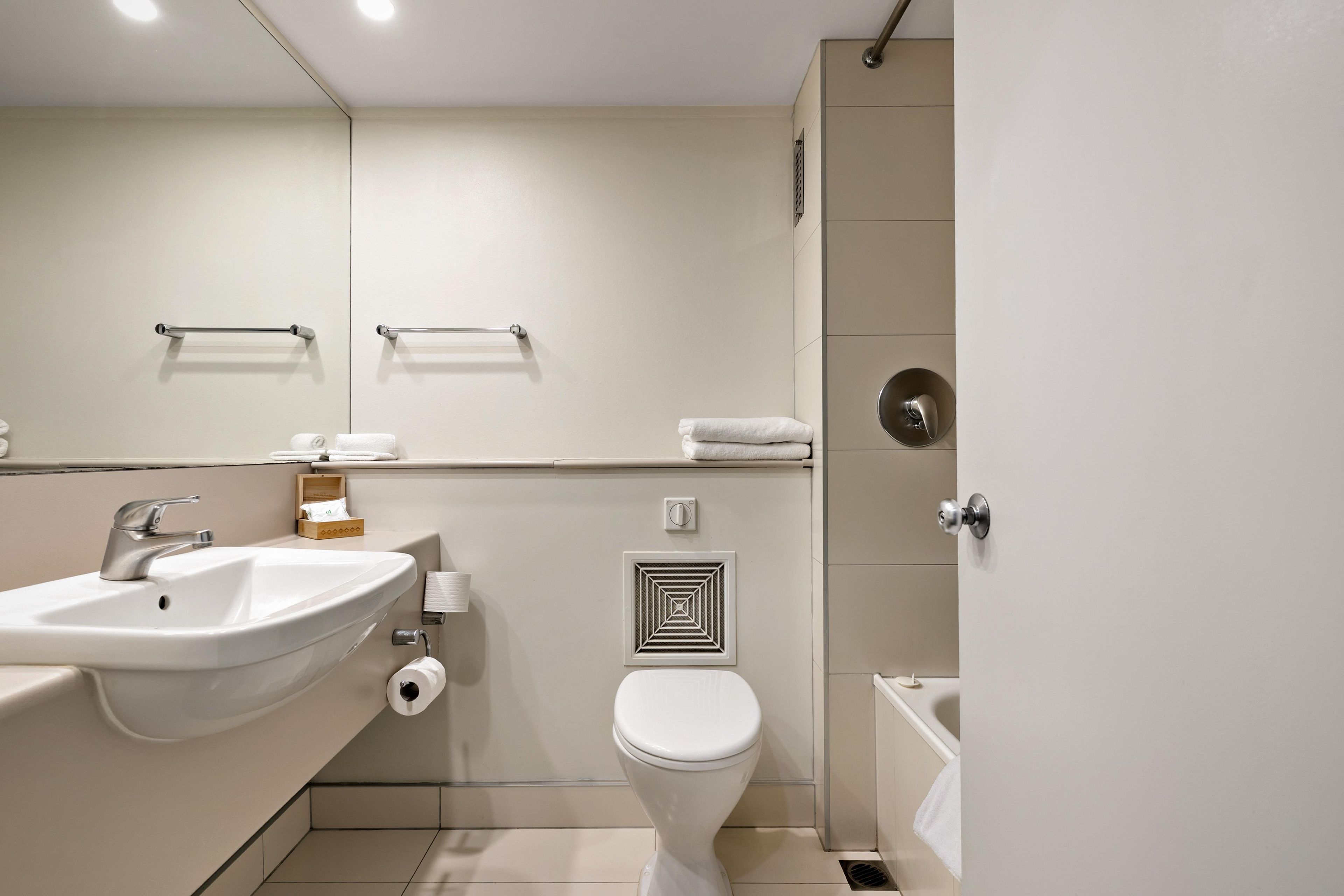 A modern bathroom with a sink, toilet, and shower.