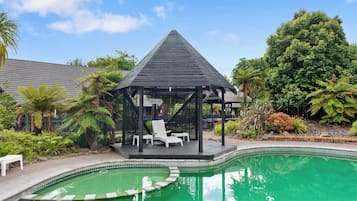 Outdoor pool, a heated pool, open 8:30 AM to 8:00 PM, pool loungers