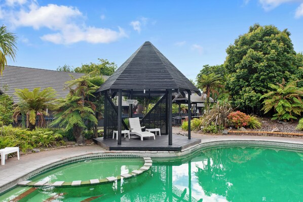 Outdoor pool, a heated pool, open 8:30 AM to 8:00 PM, pool loungers